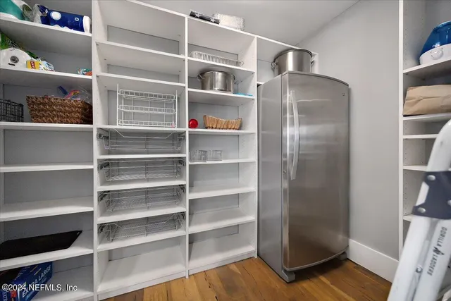 a view of a hallway with a livingroom and couch