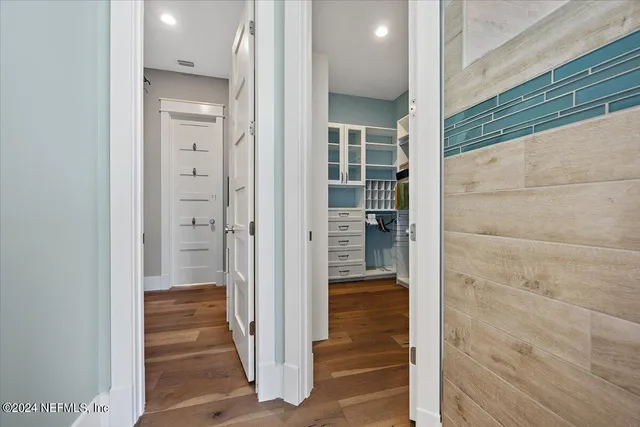 a spacious bathroom with a double vanity sink a mirror and a shower