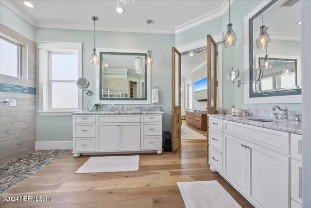 a view of a hallway with wooden floor and stairs