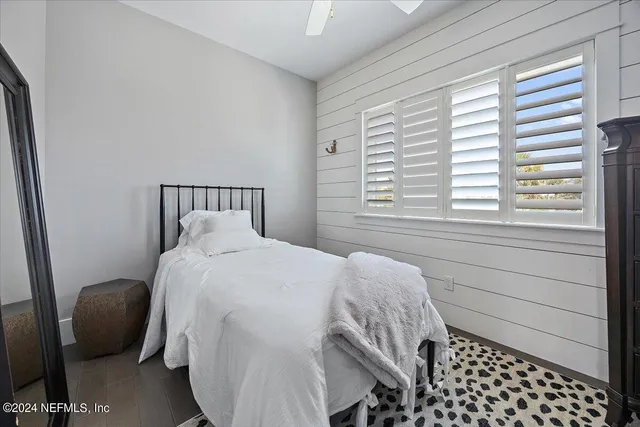 a view of bedroom with furniture and a window
