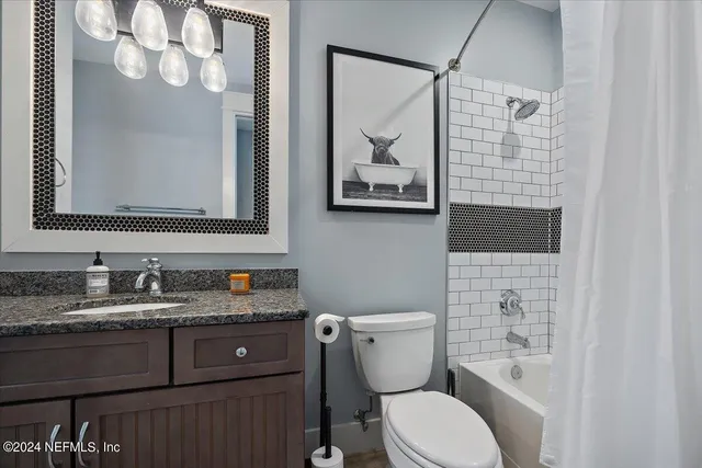 a living room with furniture a flat screen tv and a table