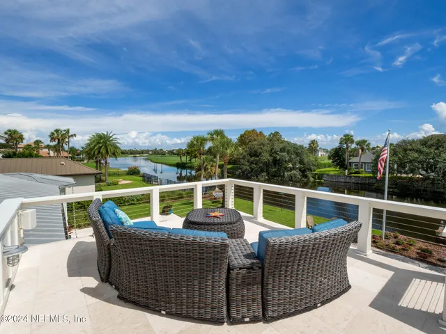 a view of a backyard with sitting area