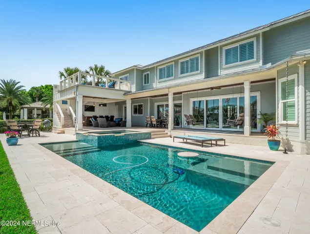 a view of a house with sitting area and swimming pool