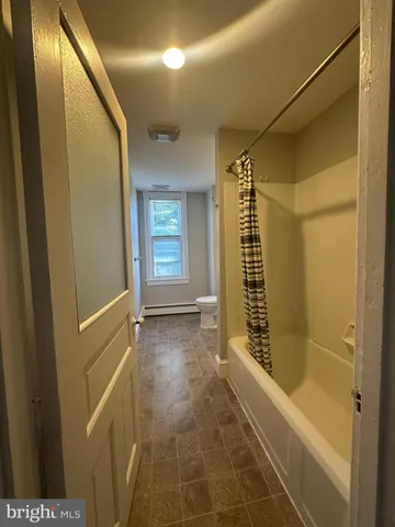a bathroom with a bathtub and shower