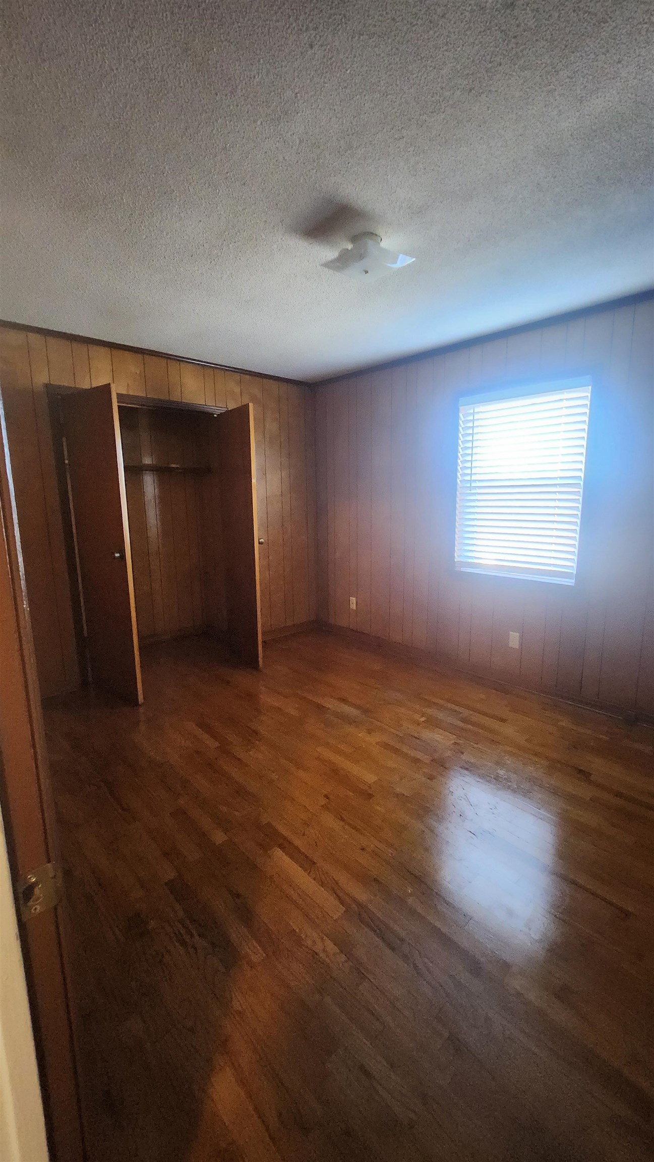 56 Riddick Street Gates, TN 38037 - Photo 9 of 10 an empty room with wooden floor and windows