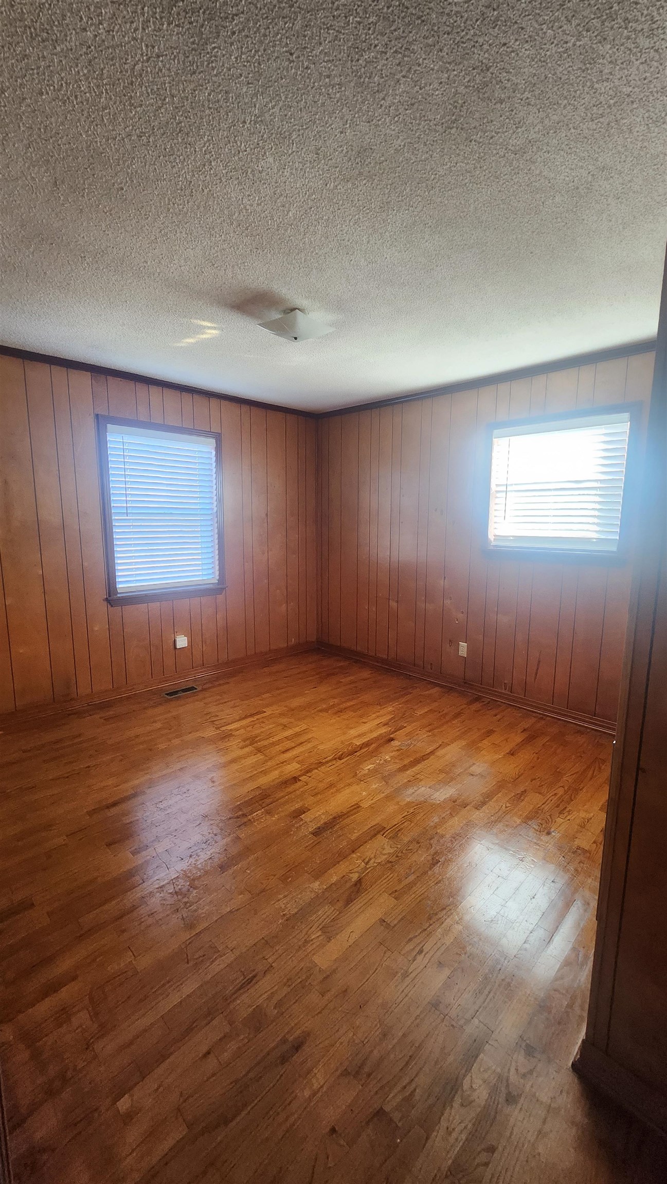 56 Riddick Street Gates, TN 38037 - Photo 10 of 10 an empty room with wooden floor and windows in it