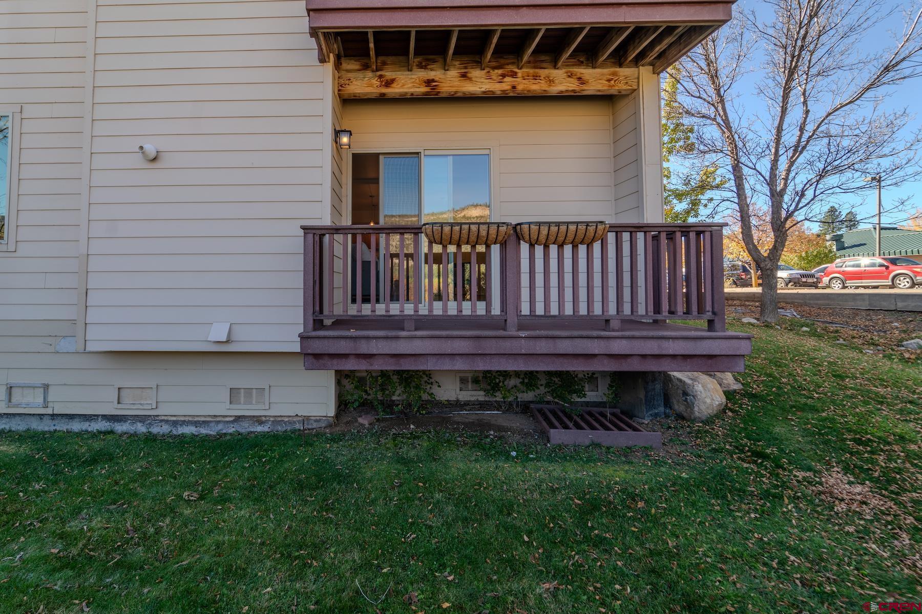 35 Sunshine Court, Unit 3 Durango, CO 81301 - Photo 21 of 26 a view of a house with a small yard and wooden fence