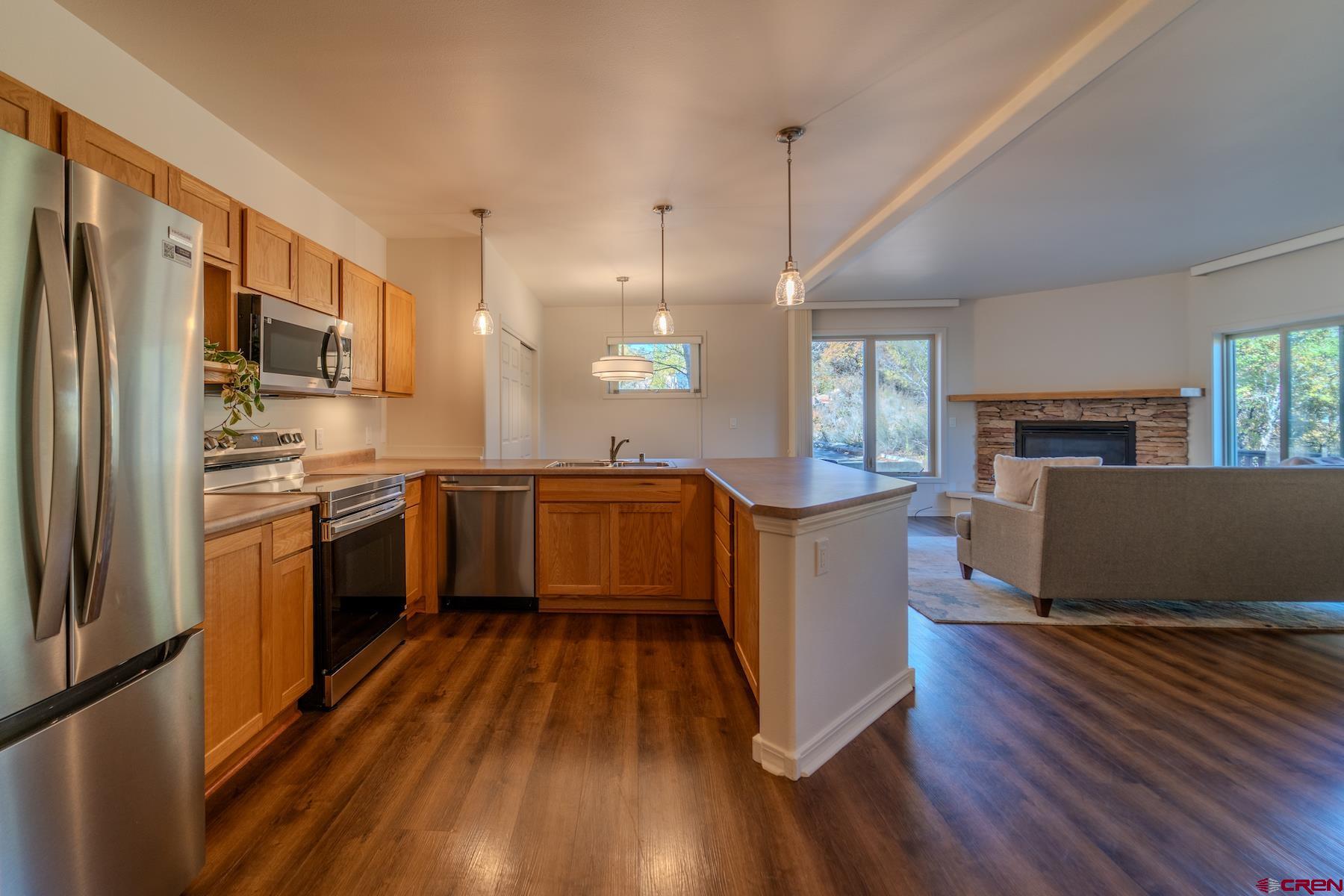 35 Sunshine Court, Unit 3 Durango, CO 81301 - Photo 4 of 26 a kitchen with stainless steel appliances a refrigerator a stove top oven and a refrigerator