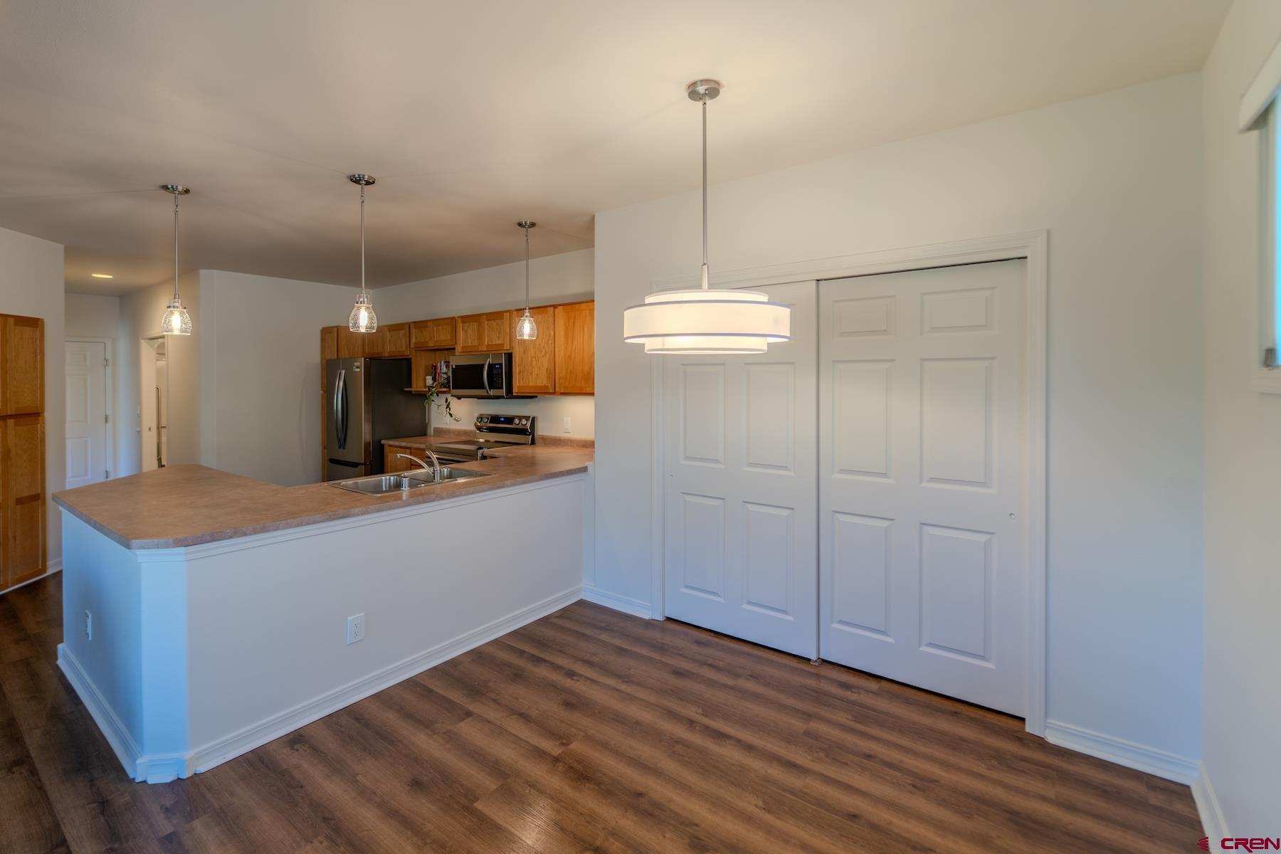 35 Sunshine Court, Unit 3 Durango, CO 81301 - Photo 8 of 26 a view of kitchen with refrigerator and wooden floor