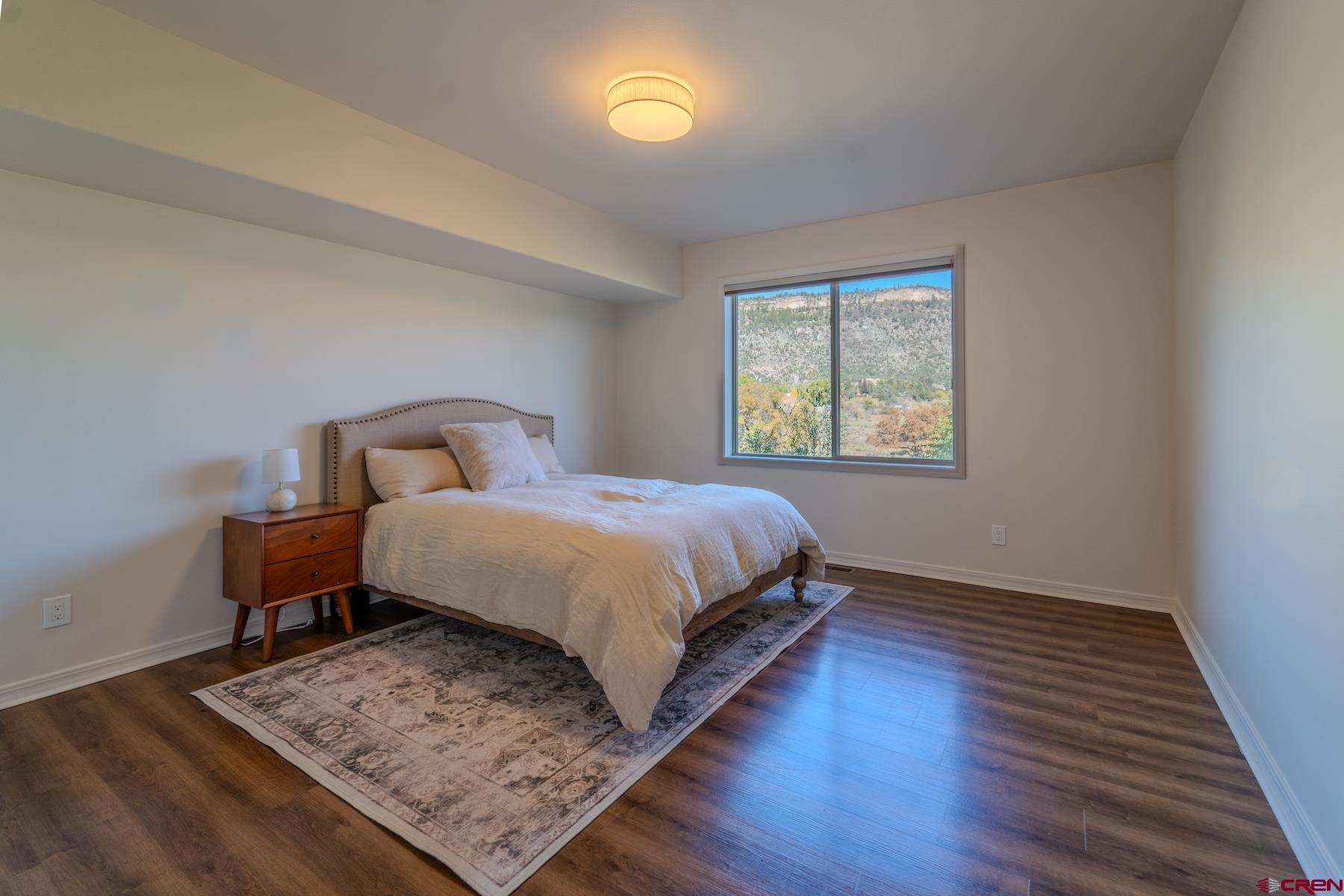 35 Sunshine Court, Unit 3 Durango, CO 81301 - Photo 10 of 26 a bedroom with a bed and wooden floor