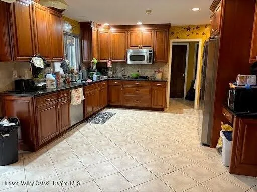 a kitchen with stainless steel appliances a sink cabinets and a counter top space