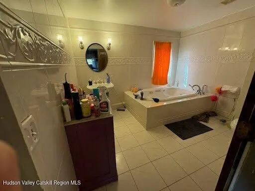 a bathroom with a sink vanity and mirror