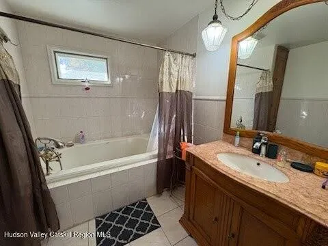 a bathroom with a tub sink and a mirror