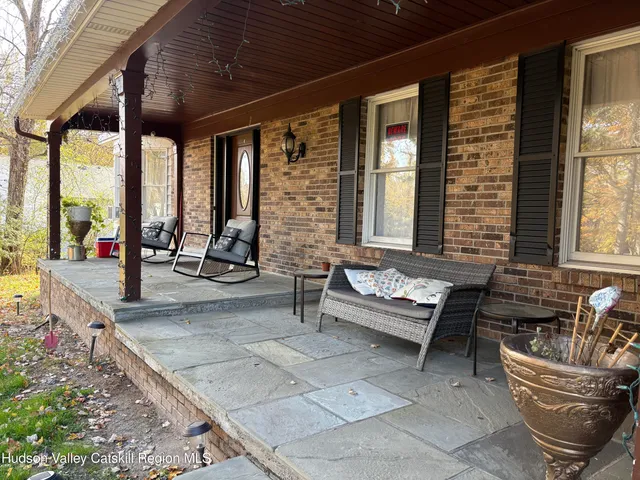 a living room with furniture and floor to ceiling windows