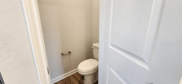 a white toilet sitting next to a shower