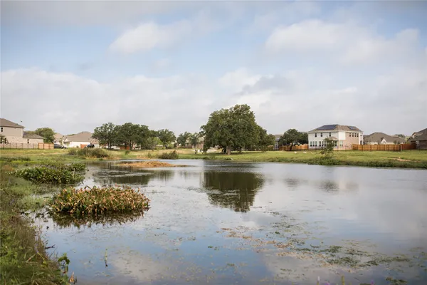 a view of a lake with houses in the back