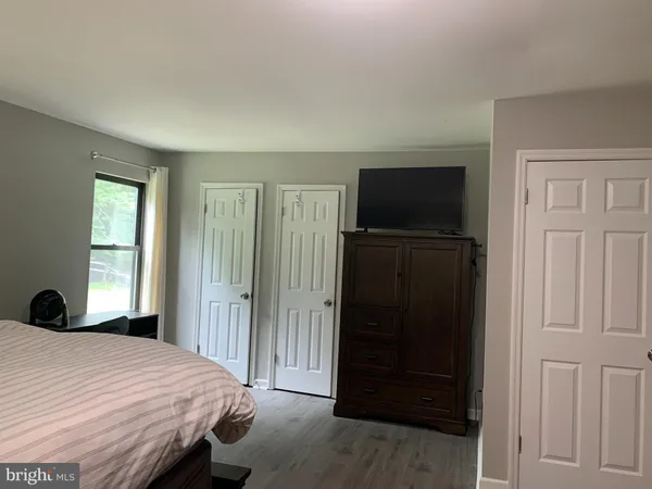 a bedroom with a bed and a television