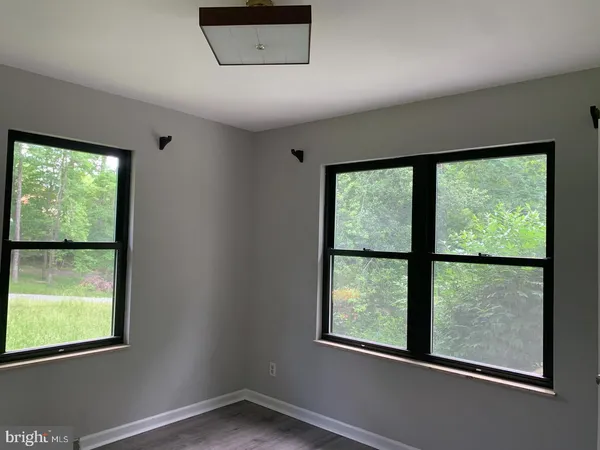 an empty room with large windows