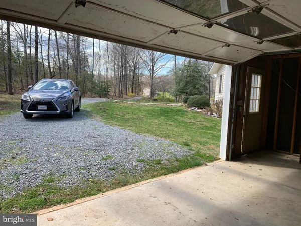 a car parked in front of yellow house