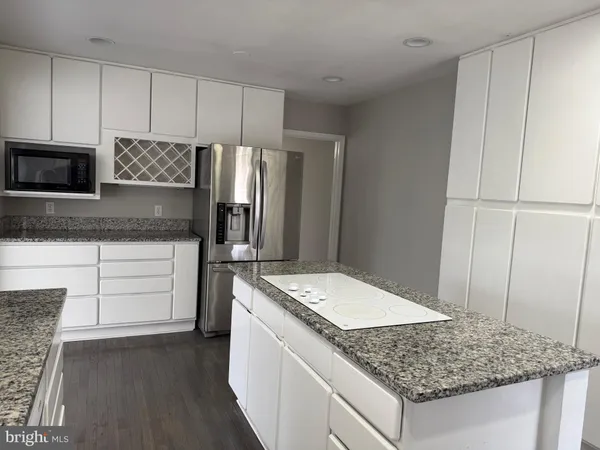 a kitchen with a sink stove and refrigerator