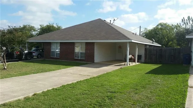 a view of a house with garden and yard