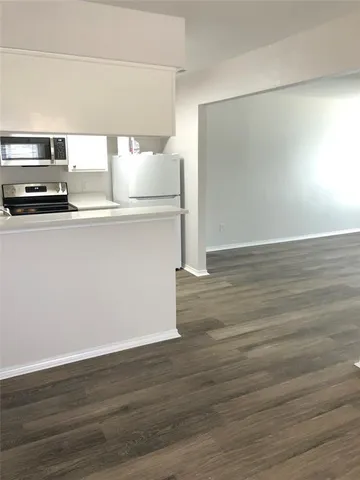 a view of kitchen with wooden floor