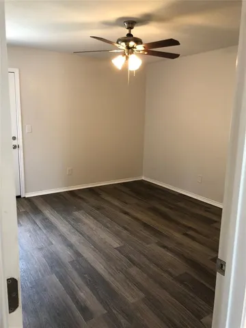 a view of a room with wooden floor and fan
