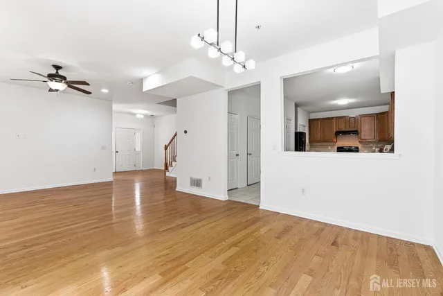 a view of a kitchen with a sink and cabinet with wooden floor