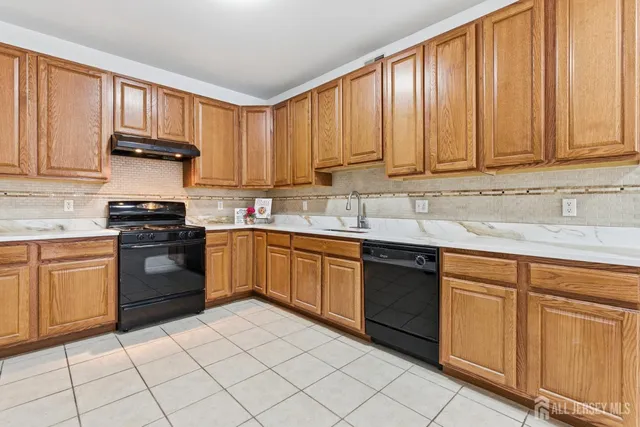 a kitchen with cabinets a sink and appliances