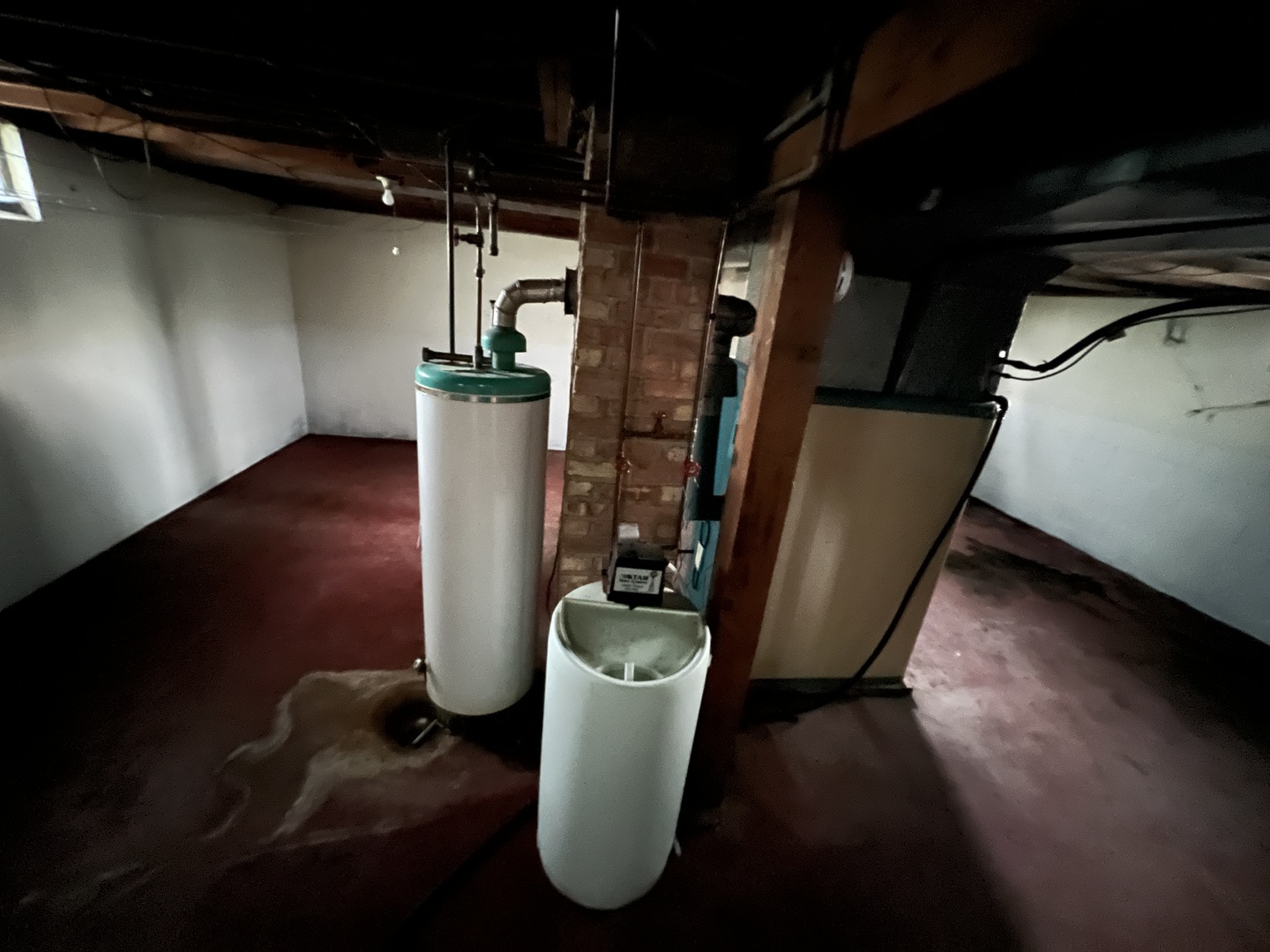 626 Woolf Court Rochelle, IL 61068 - Photo 17 of 23 a view of a storage room with water heater and wooden floor