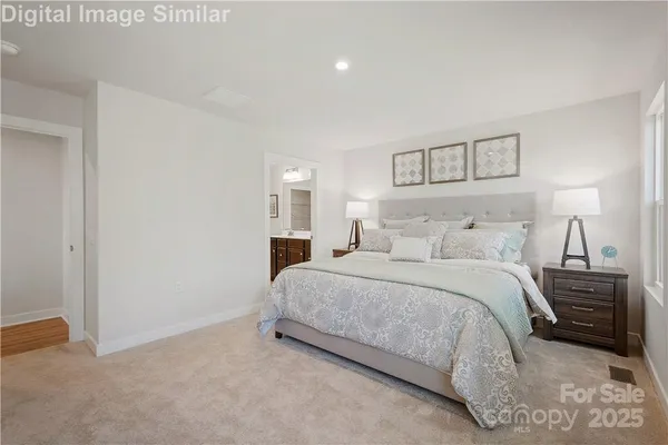 a bedroom with a bed and a night stand