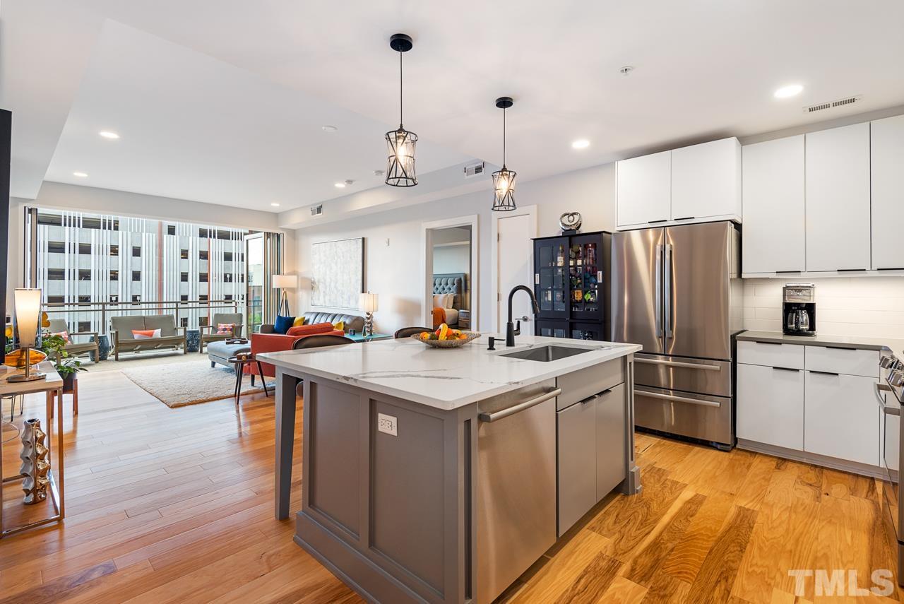 400 Hunt Street, Unit 406 Durham, NC 27701 - Photo 2 of 34 a kitchen with stainless steel appliances granite countertop a stove and refrigerator