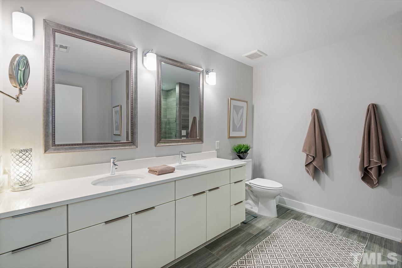 400 Hunt Street, Unit 406 Durham, NC 27701 - Photo 21 of 34 a bathroom with a double vanity sink and mirror