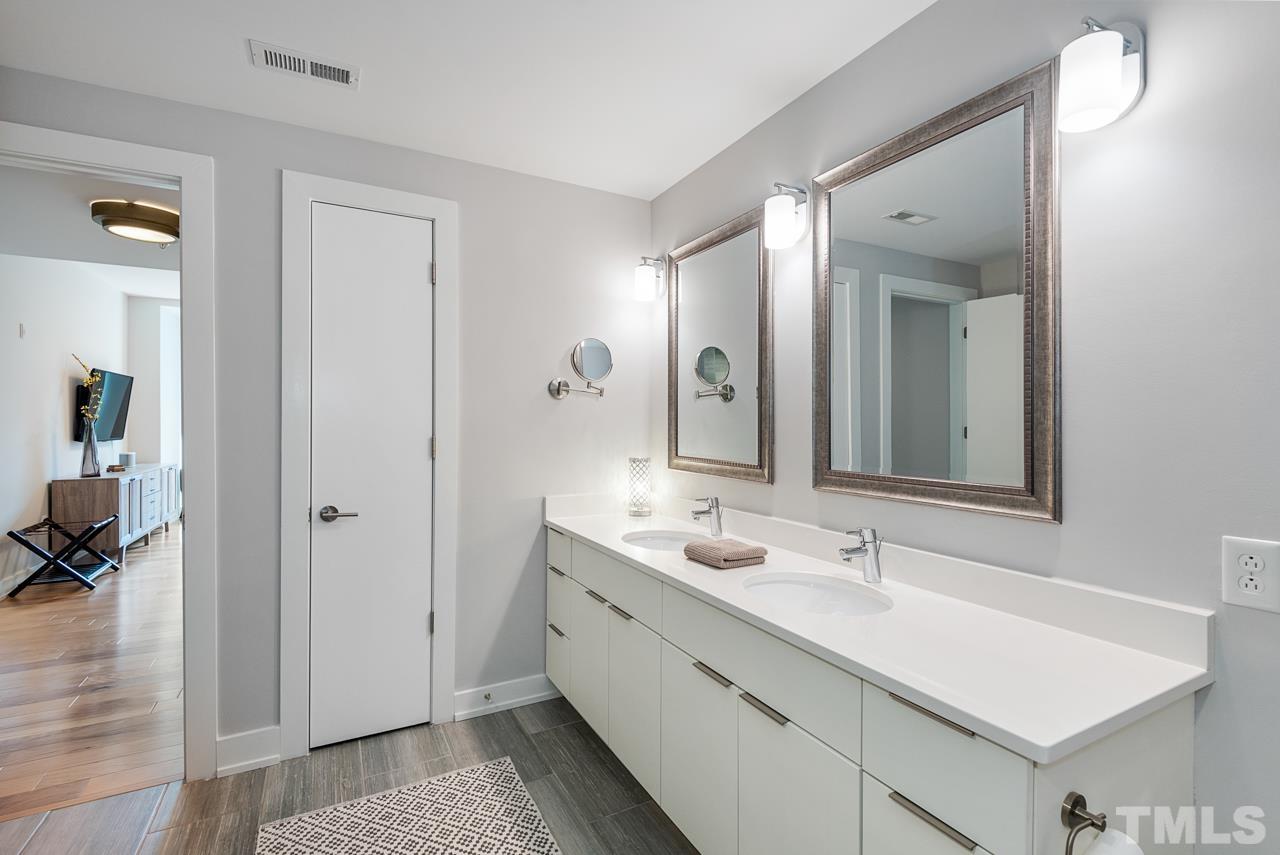 400 Hunt Street, Unit 406 Durham, NC 27701 - Photo 23 of 34 a bathroom with a double vanity sink and mirror