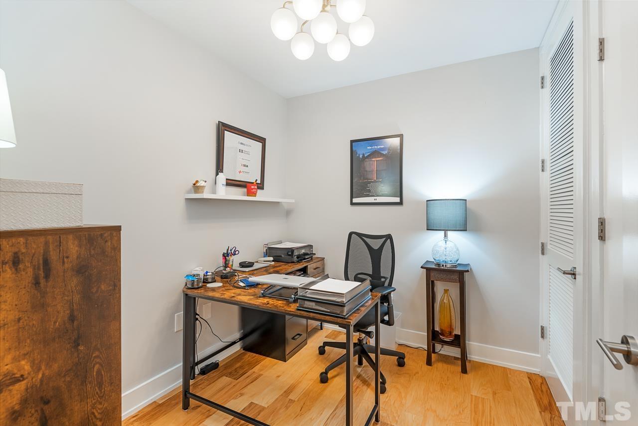 400 Hunt Street, Unit 406 Durham, NC 27701 - Photo 29 of 34 a view of a workspace with furniture and a chandelier fan