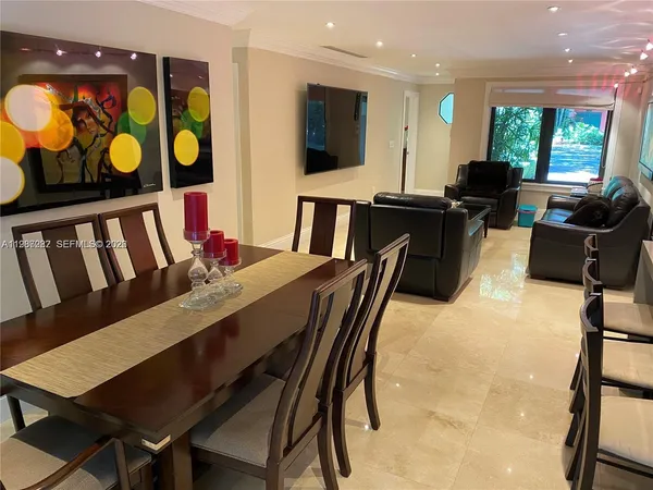 a view of a dining room with furniture and window