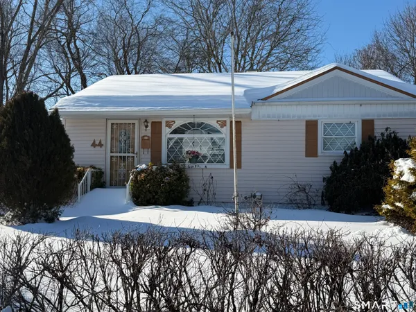 a view of a house with yard and sitting area