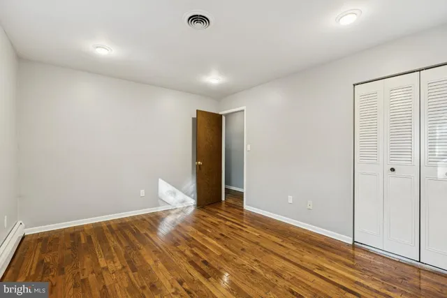a view of room with wooden floor