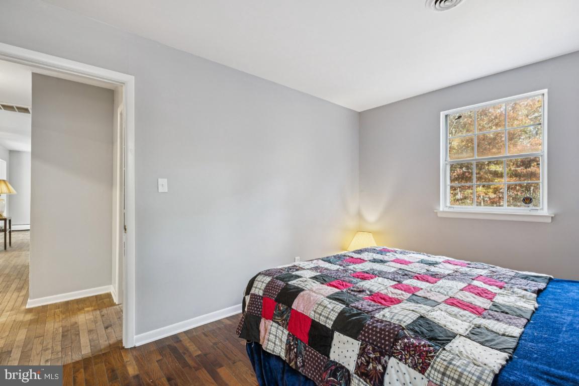 207 Sooy Place Road Tabernacle, NJ 08088 - Photo 13 of 25 a bedroom with a bed and wooden floor