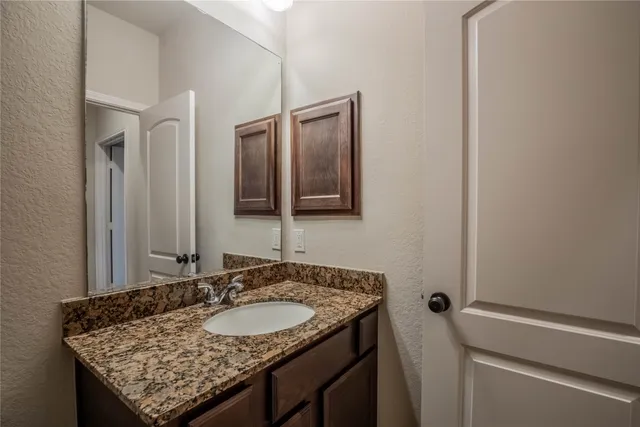 a kitchen with stainless steel appliances kitchen island granite countertop a refrigerator and a stove top oven