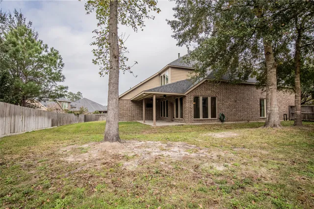 a view of a house with yard and tree s
