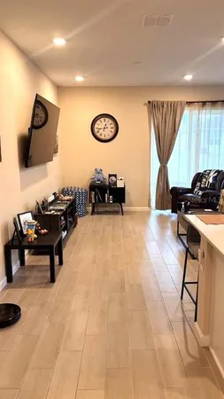 a room with stainless steel appliances kitchen island granite countertop a stove a sink and a refrigerator