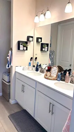 a bathroom with a sink a toilet and a shower curtain