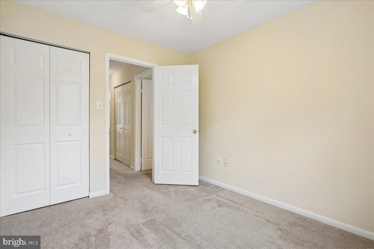 9752 High Water Court Burke, VA 22015 - Photo 12 of 25 an empty room with a ceiling fan