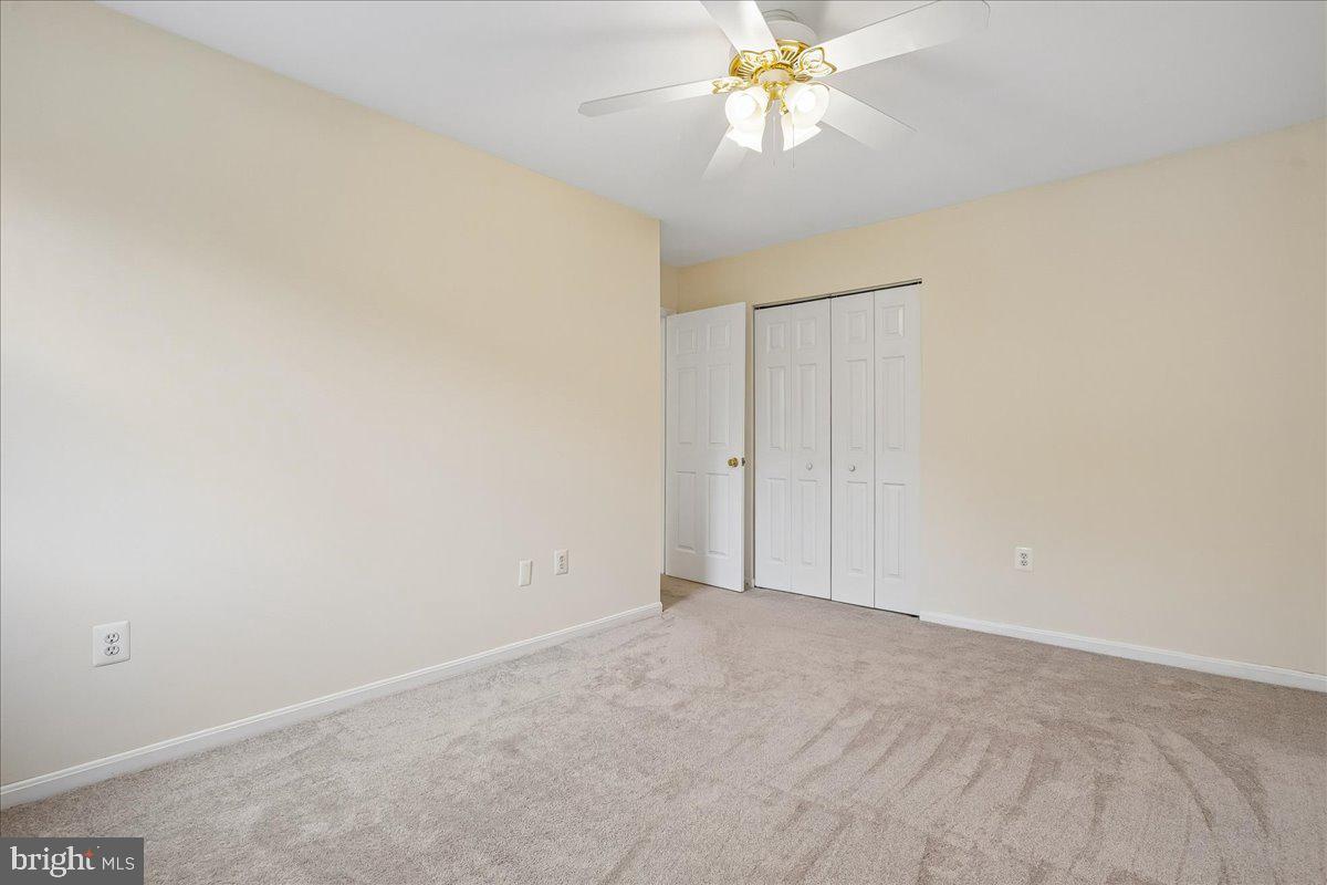 9752 High Water Court Burke, VA 22015 - Photo 14 of 25 a view of an empty room with a chandelier fan