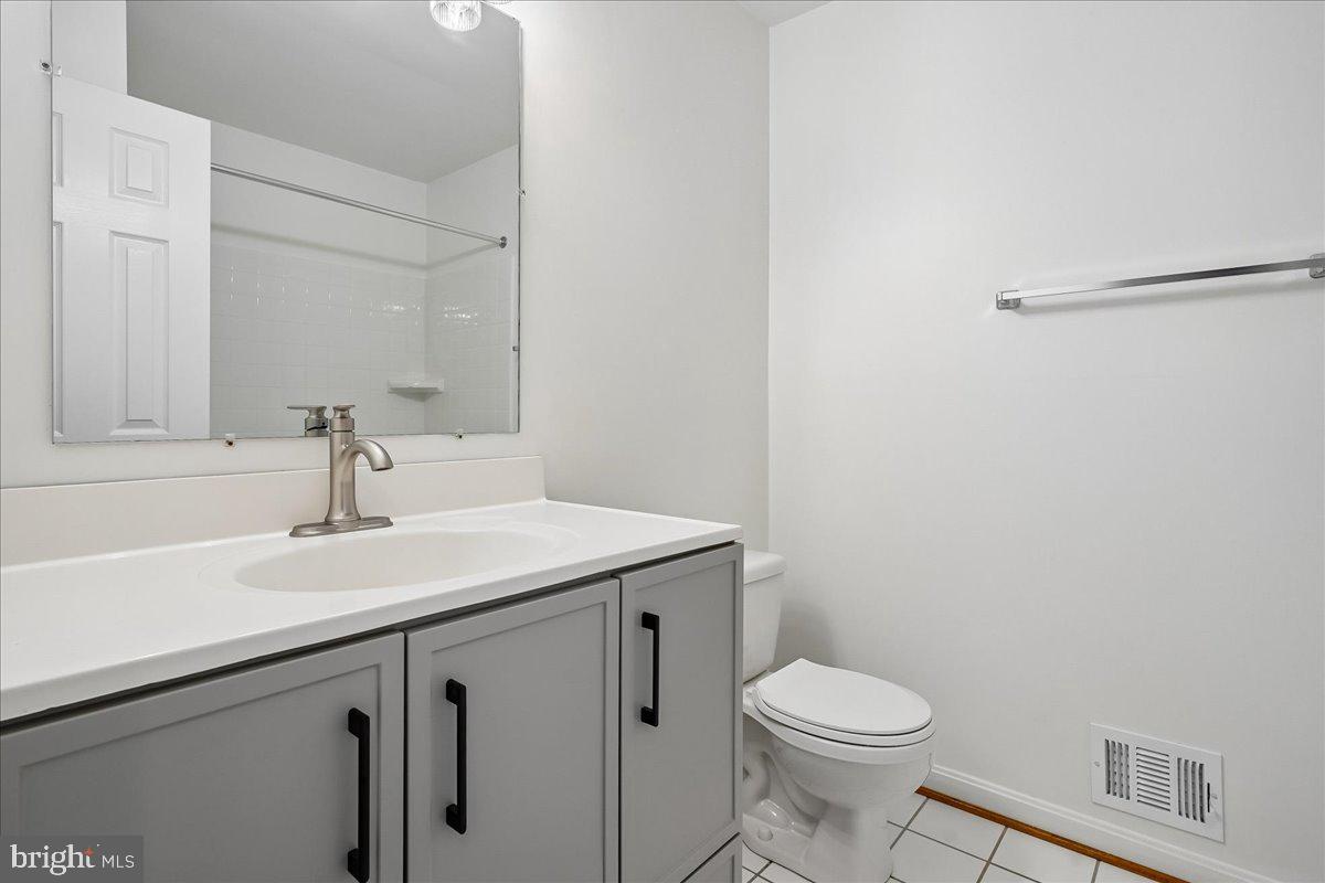 9752 High Water Court Burke, VA 22015 - Photo 15 of 25 a bathroom with a sink a toilet and a mirror