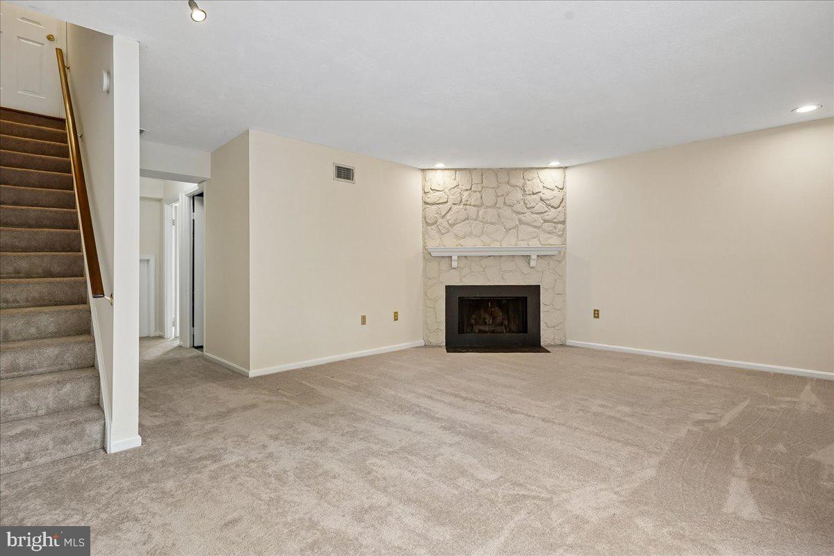 9752 High Water Court Burke, VA 22015 - Photo 16 of 25 a view of an empty room with a fireplace