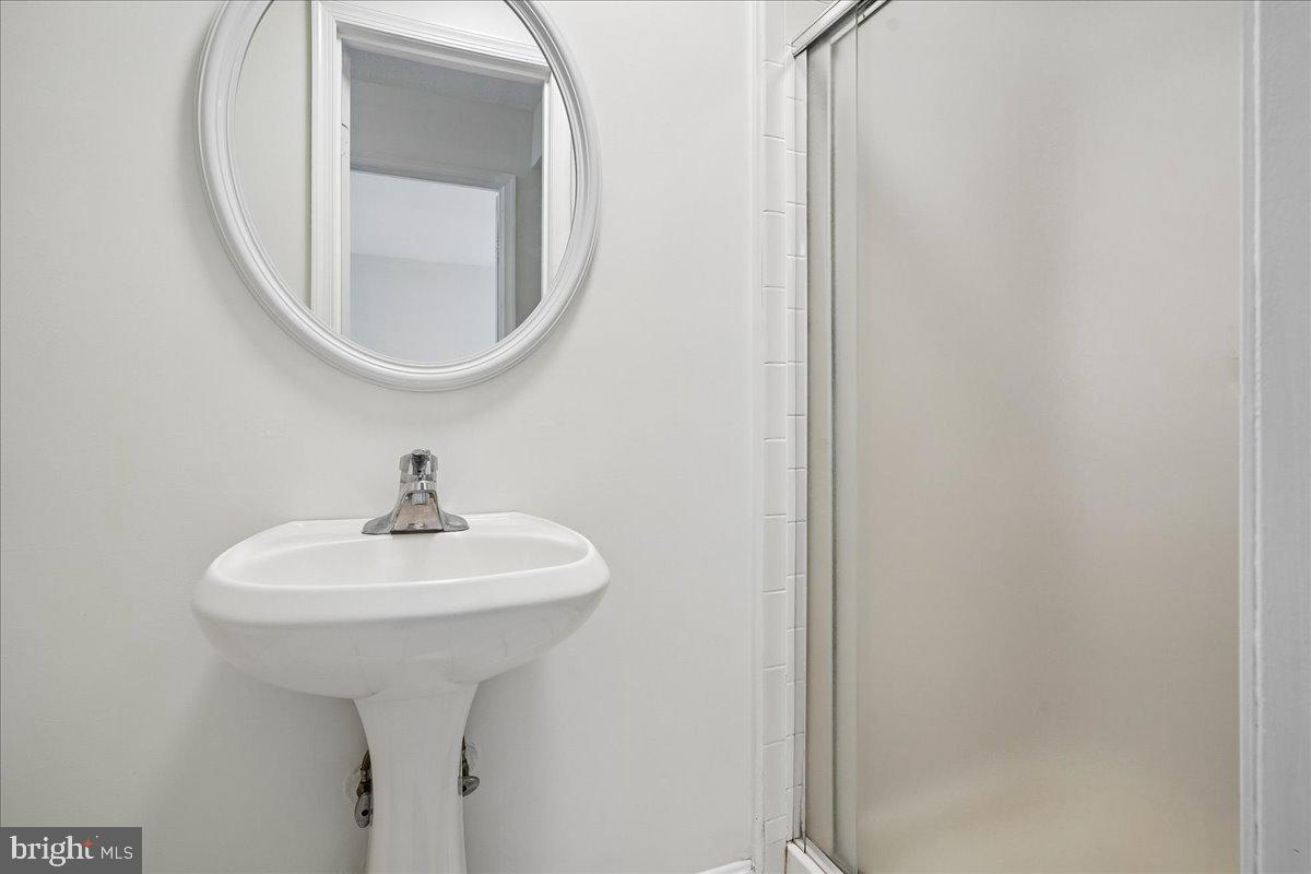 9752 High Water Court Burke, VA 22015 - Photo 19 of 25 a bathroom with a sink and a mirror