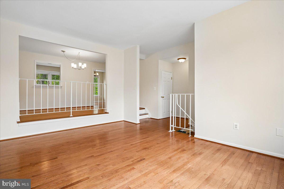 9752 High Water Court Burke, VA 22015 - Photo 2 of 25 an empty room with wooden floor and a window