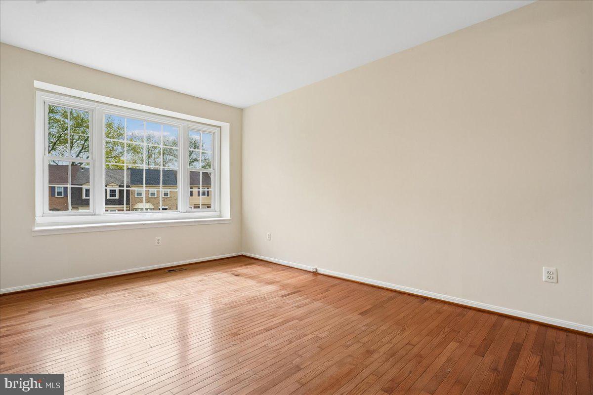 9752 High Water Court Burke, VA 22015 - Photo 3 of 25 a view of an empty room with wooden floor and a window